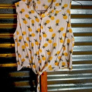 This is a mid-riff style “tie at the bottom”, sleeve-less blouse.